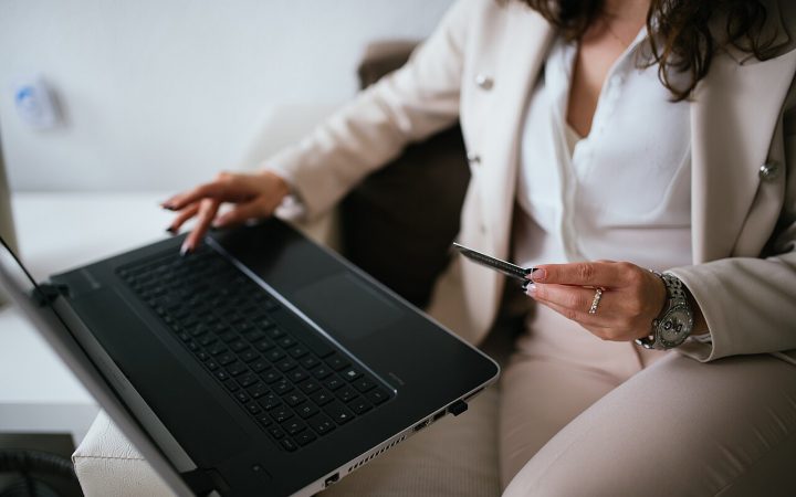 Professional making an online payment with a card and laptop
