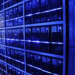 Rows of illuminated server racks in a modern data center