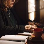 Businesswoman reading email on a laptop in a dim office
