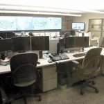 Network operations center with monitoring screens