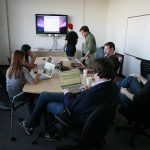 Team working with laptops in a conference room