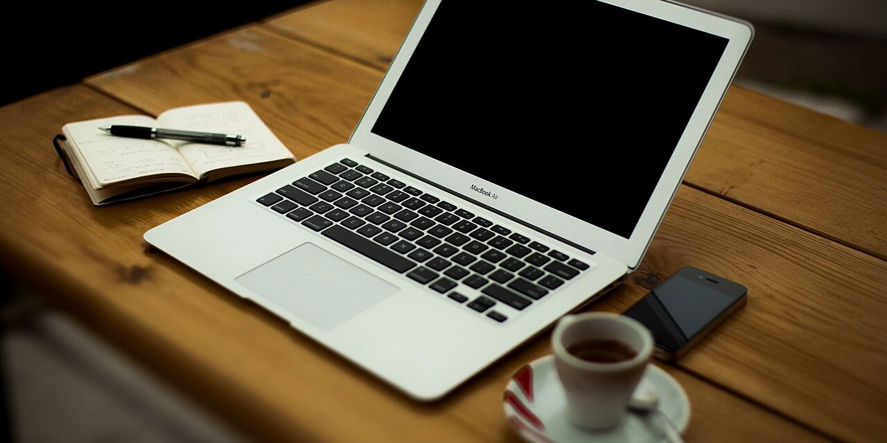 Laptop and coffee cup on a small business desk