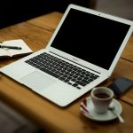 Laptop and coffee cup on a small business desk