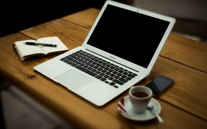Laptop and coffee cup on a small business desk