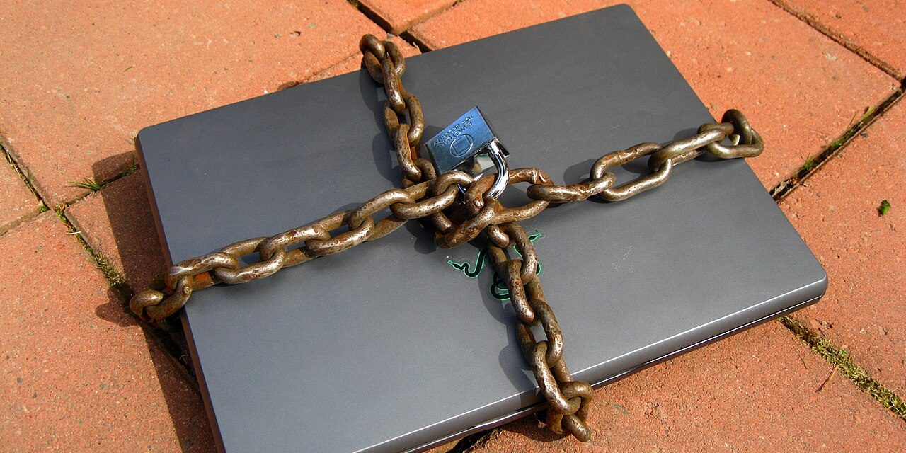 Laptop secured with a chain and padlock