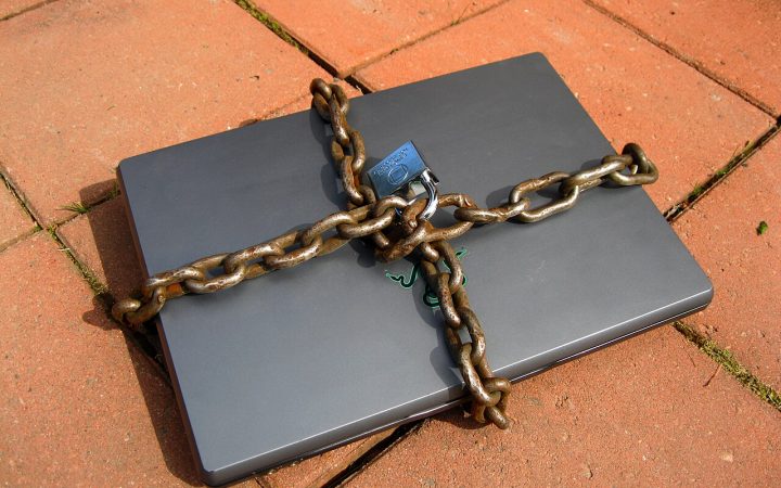 Laptop secured with a chain and padlock
