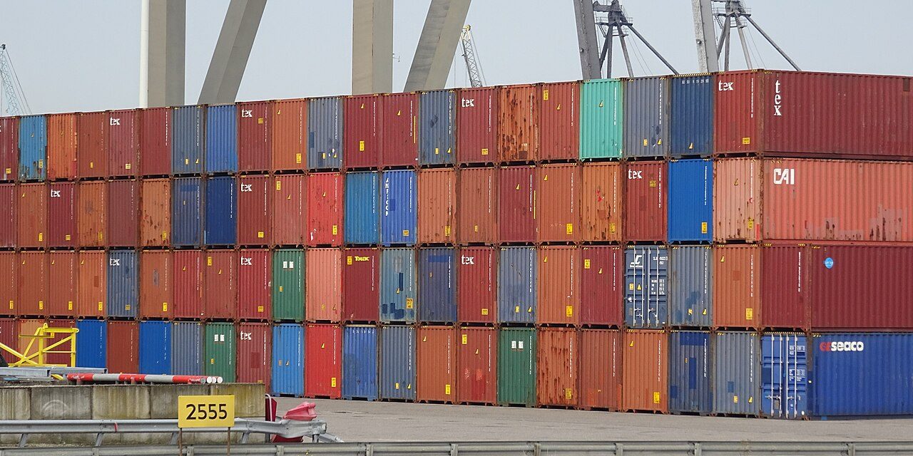 Stacked shipping containers representing the supply chain