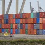Stacked shipping containers representing the supply chain