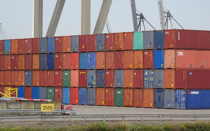 Stacked shipping containers representing the supply chain