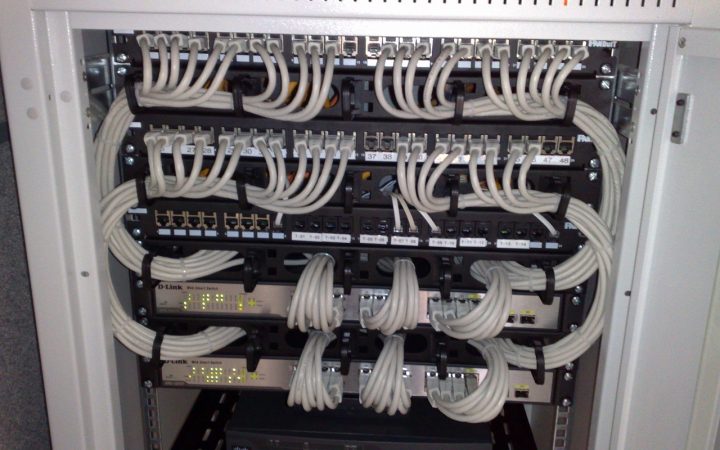 Rack-mounted Ethernet switches and patch panels being reviewed